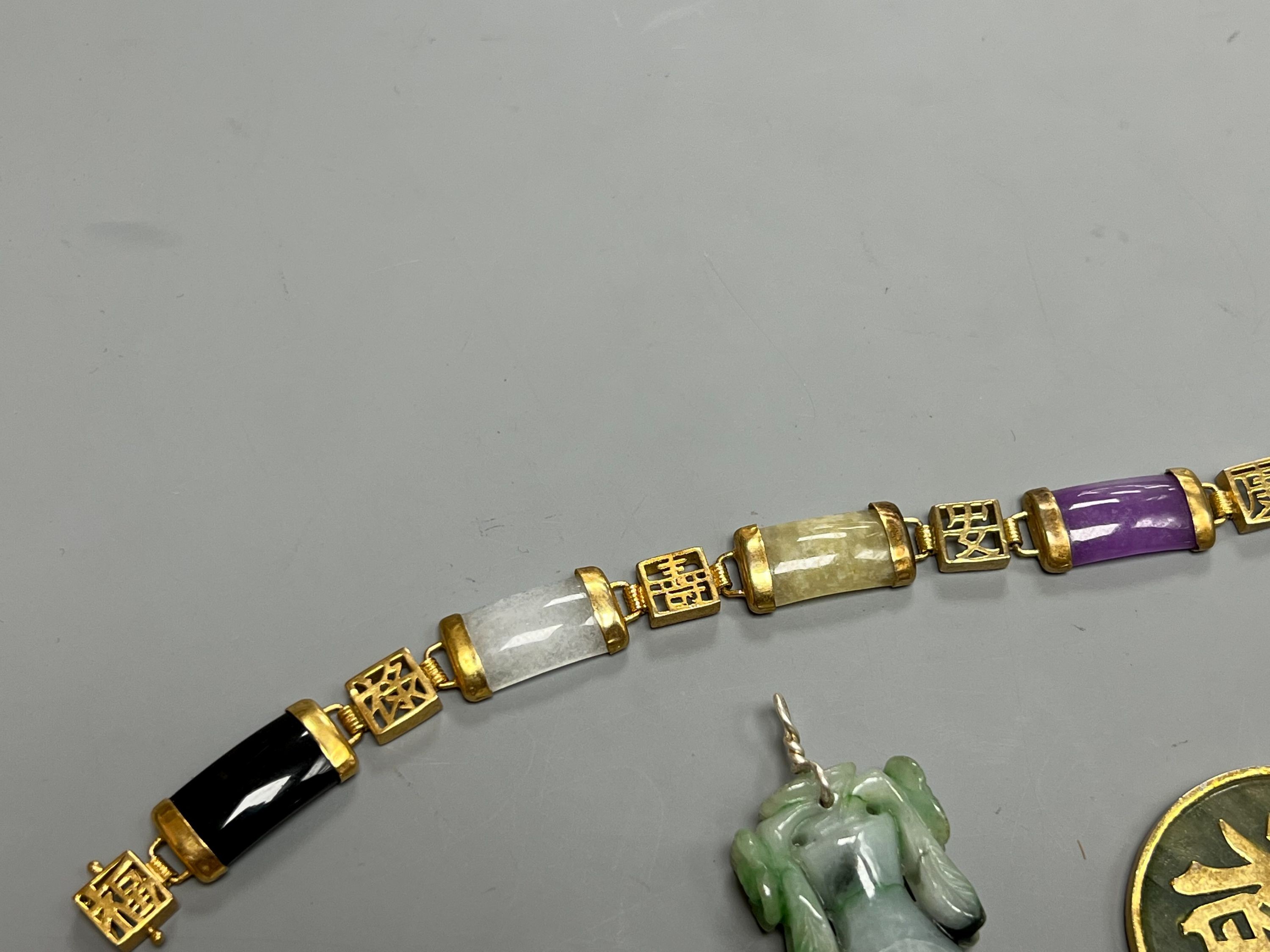 A Chinese multi coloured jadeite bracelet, and two jadeite pendants